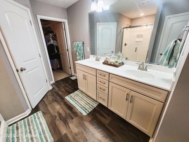 12630 Orell Station Pl, Louisville, KY 40272 - bathroom with a stall shower, double vanity, wood finished floors, and a spacious closet