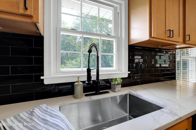 3407 Hillsboro Rd, Louisville, KY 40207 - kitchen view of backsplash, brown cabinets, and light stone counters