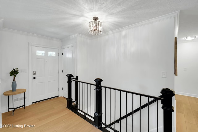 3407 Hillsboro Rd, Louisville, KY 40207 - entrance foyer with light wood-style flooring, a chandelier, and ornamental molding
