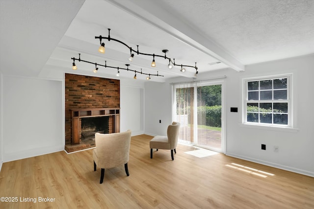 3407 Hillsboro Rd, Louisville, KY 40207 - living area with light wood finished floors, a fireplace, and beamed ceiling