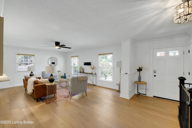 3407 Hillsboro Rd, Louisville, KY 40207 - living room featuring plenty of natural light, ceiling fan, light wood-style flooring, and a chandelier