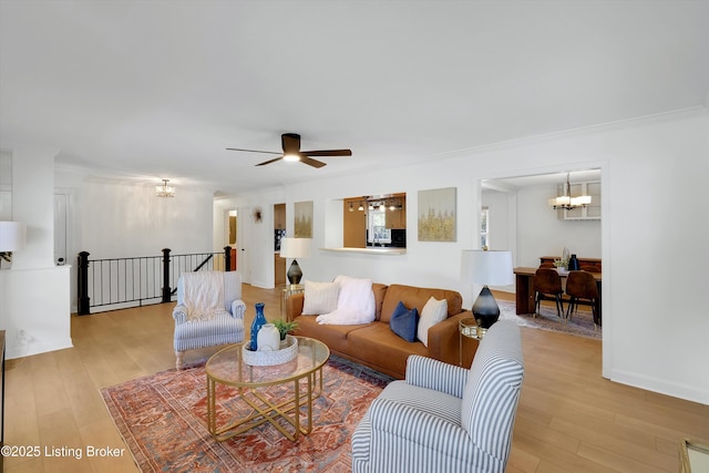 3407 Hillsboro Rd, Louisville, KY 40207 - living room with a chandelier, light wood finished floors, and a ceiling fan