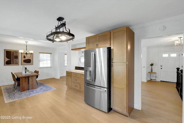 3407 Hillsboro Rd, Louisville, KY 40207 - kitchen with stainless steel fridge, a chandelier, light wood finished floors, crown molding, and decorative light fixtures