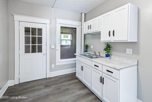 2522 Wilson Ave, Louisville, KY 40210 - kitchen featuring light countertops, white cabinets, and wood finished floors