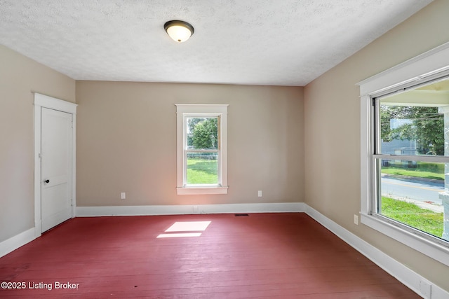 2522 Wilson Ave, Louisville, KY 40210 - empty room with dark wood-type flooring, plenty of natural light, and a textured ceiling