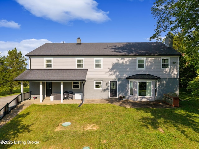 10020 Oak Grove Rd, Louisville, KY 40291 - back of house featuring a chimney, a lawn, and a patio area