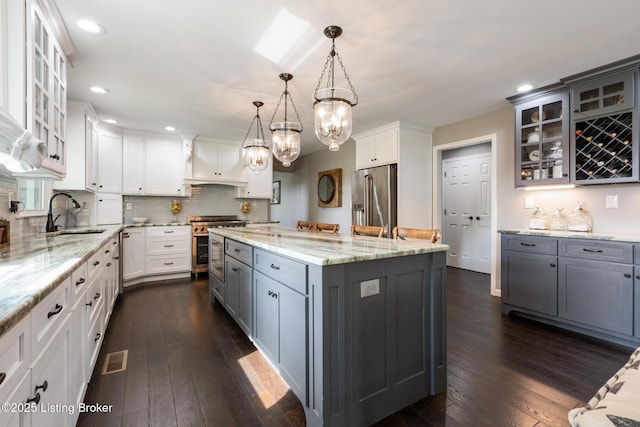 10020 Oak Grove Rd, Louisville, KY 40291 - kitchen featuring premium appliances, a center island, gray cabinets, white cabinetry, and recessed lighting