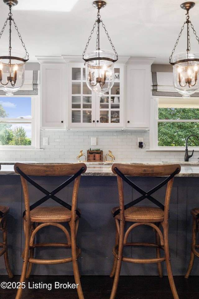 10020 Oak Grove Rd, Louisville, KY 40291 - kitchen featuring a chandelier, glass insert cabinets, white cabinetry, and pendant lighting