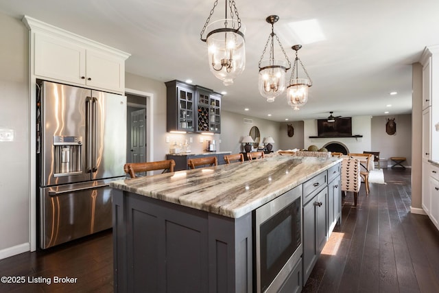 10020 Oak Grove Rd, Louisville, KY 40291 - kitchen featuring stainless steel appliances, recessed lighting, light stone counters, gray cabinets, and a center island