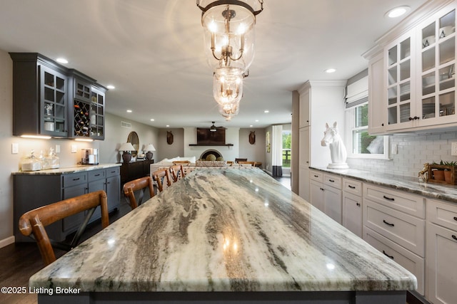 10020 Oak Grove Rd, Louisville, KY 40291 - dining area featuring wet bar, recessed lighting, dark wood finished floors, and a chandelier