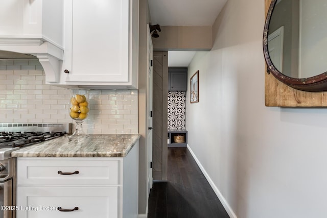 10020 Oak Grove Rd, Louisville, KY 40291 - kitchen featuring stainless steel gas range oven, backsplash, dark wood-style flooring, white cabinetry, and light stone counters