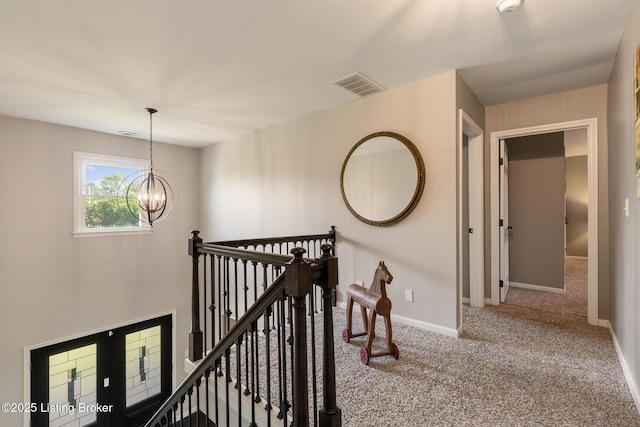 10020 Oak Grove Rd, Louisville, KY 40291 - hall with carpet floors, an upstairs landing, and a chandelier