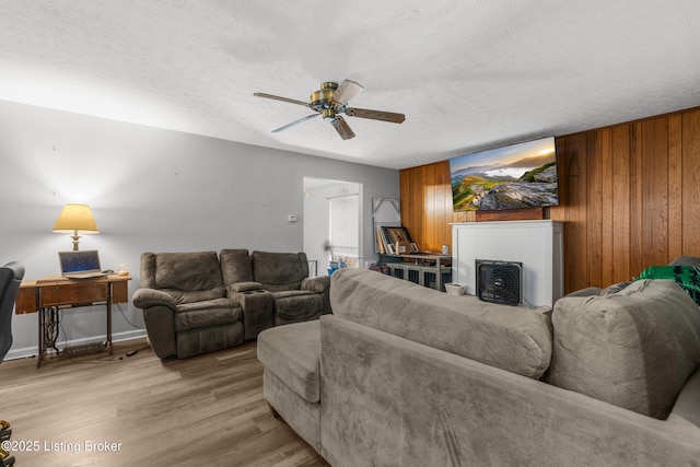 2625 Shumate Rd, Ekron, KY 40117 - living area featuring a ceiling fan, a textured ceiling, wood finished floors, and wooden walls