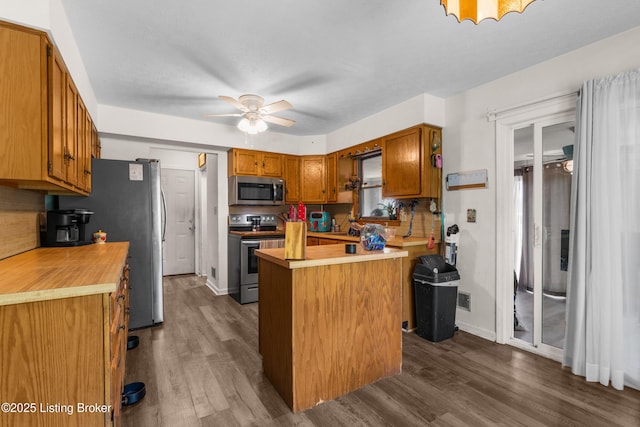 2625 Shumate Rd, Ekron, KY 40117 - kitchen featuring appliances with stainless steel finishes, dark wood-style floors, a kitchen island, and a ceiling fan