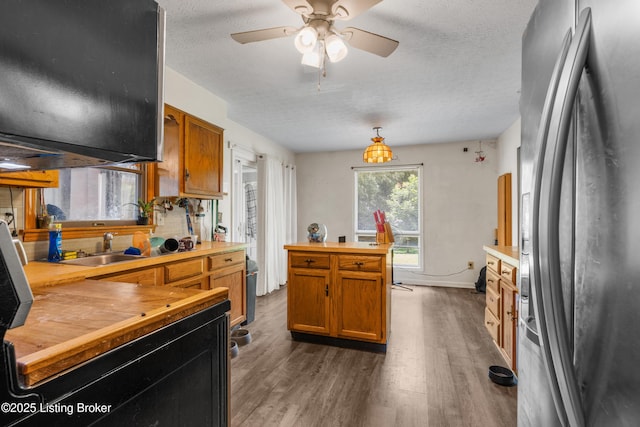 2625 Shumate Rd, Ekron, KY 40117 - kitchen featuring freestanding refrigerator, butcher block counters, dark wood-type flooring, a textured ceiling, and ceiling fan