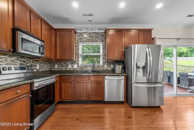 10008 Hornbeam Blvd, Louisville, KY 40228 - kitchen with appliances with stainless steel finishes, healthy amount of natural light, tasteful backsplash, wood finished floors, and crown molding