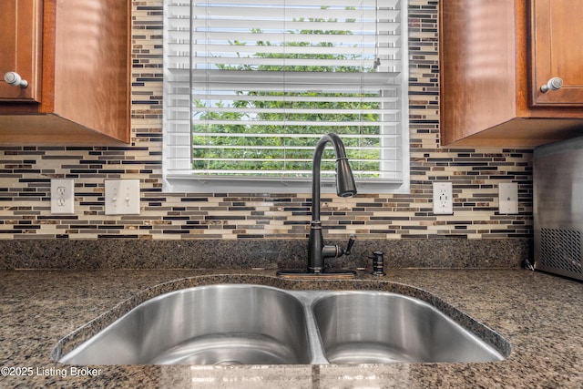 10008 Hornbeam Blvd, Louisville, KY 40228 - kitchen view of brown cabinetry, backsplash, and dark stone countertops