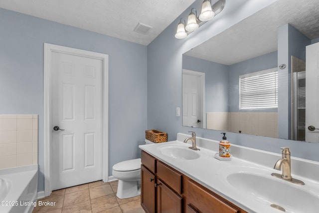 10008 Hornbeam Blvd, Louisville, KY 40228 - bathroom featuring double vanity, a garden tub, tile patterned flooring, and a textured ceiling
