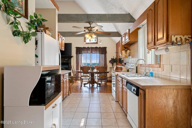 4333 Wax Rd, Clarkson, KY 42726 - kitchen featuring white dishwasher, tile counters, ceiling fan, decorative backsplash, and brown cabinetry