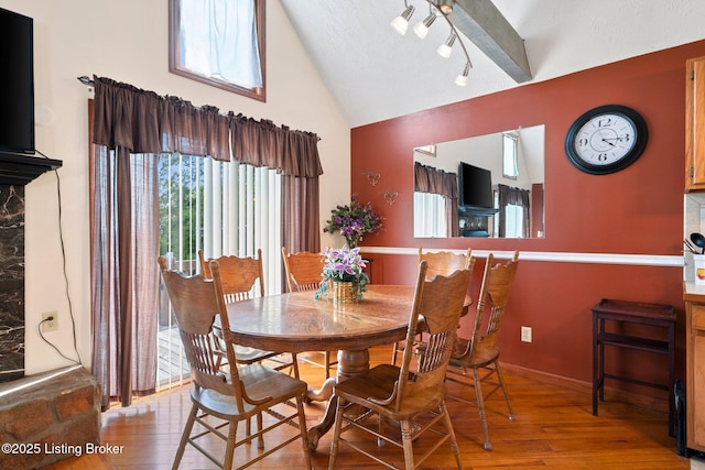 4333 Wax Rd, Clarkson, KY 42726 - dining room featuring hardwood / wood-style flooring, rail lighting, high vaulted ceiling, and a textured ceiling