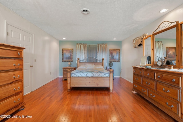 4333 Wax Rd, Clarkson, KY 42726 - bedroom featuring hardwood / wood-style floors, a textured ceiling, and recessed lighting