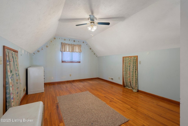 4333 Wax Rd, Clarkson, KY 42726 - additional living space with light wood-type flooring, a textured ceiling, vaulted ceiling, and ceiling fan