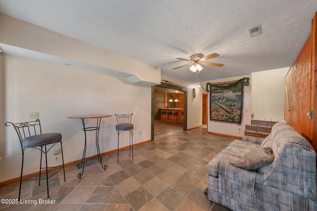 4333 Wax Rd, Clarkson, KY 42726 - living room featuring a ceiling fan, stone finish floors, and a textured ceiling