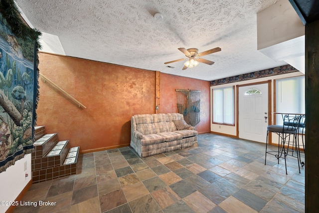 4333 Wax Rd, Clarkson, KY 42726 - sitting room featuring stone tile floors, ceiling fan, a textured ceiling, and stairs