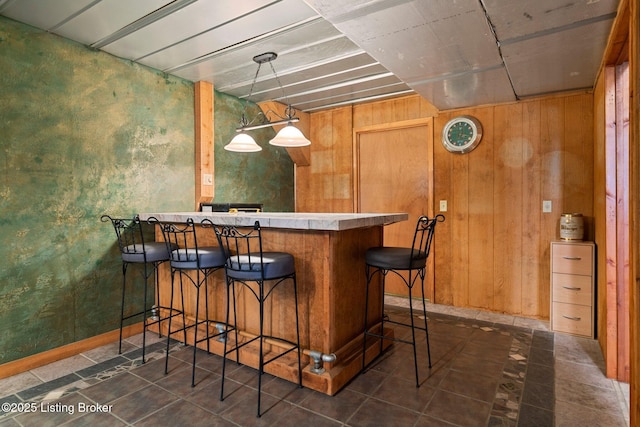 4333 Wax Rd, Clarkson, KY 42726 - indoor dry bar featuring wood walls, hanging light fixtures, and dark tile patterned floors