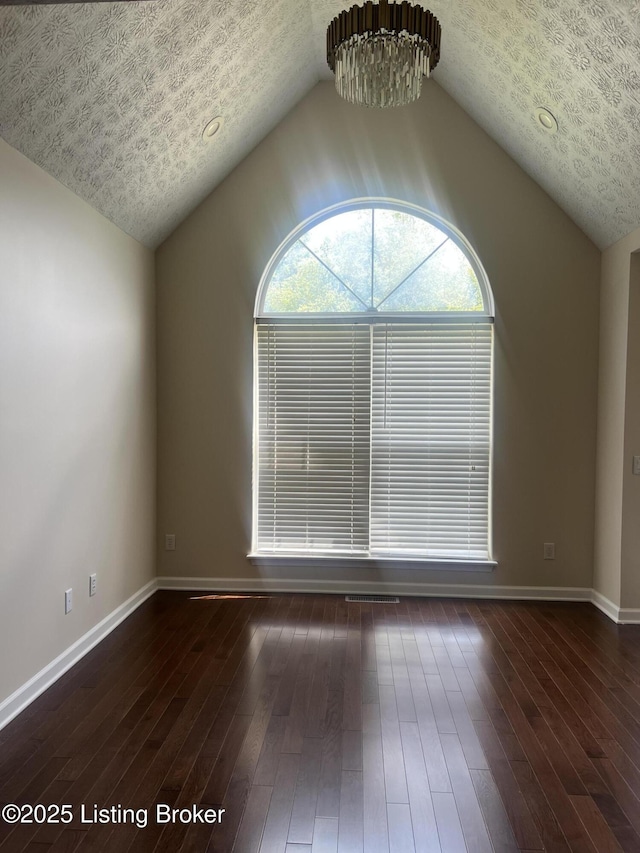 9403 Alex Ct, Louisville, KY 40299 - empty room featuring lofted ceiling, dark wood-type flooring, and a chandelier