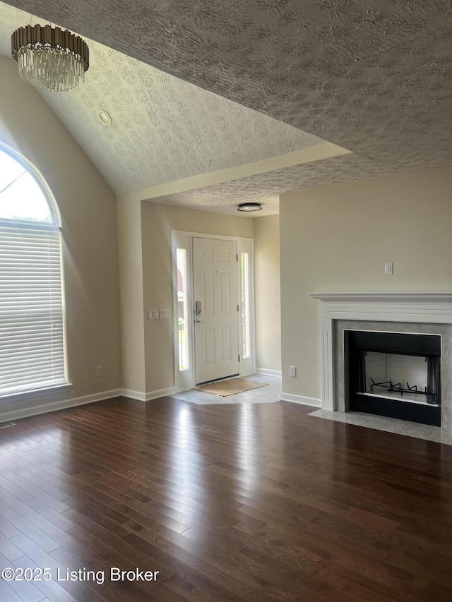 9403 Alex Ct, Louisville, KY 40299 - entryway with a textured ceiling, wood finished floors, a fireplace with flush hearth, plenty of natural light, and vaulted ceiling