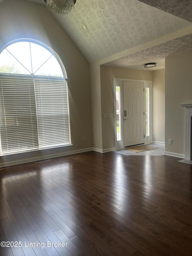 9403 Alex Ct, Louisville, KY 40299 - entrance foyer with lofted ceiling, wood finished floors, and a textured ceiling