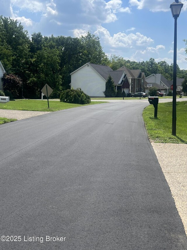 9403 Alex Ct, Louisville, KY 40299 - view of asphalt road featuring traffic signs and street lights