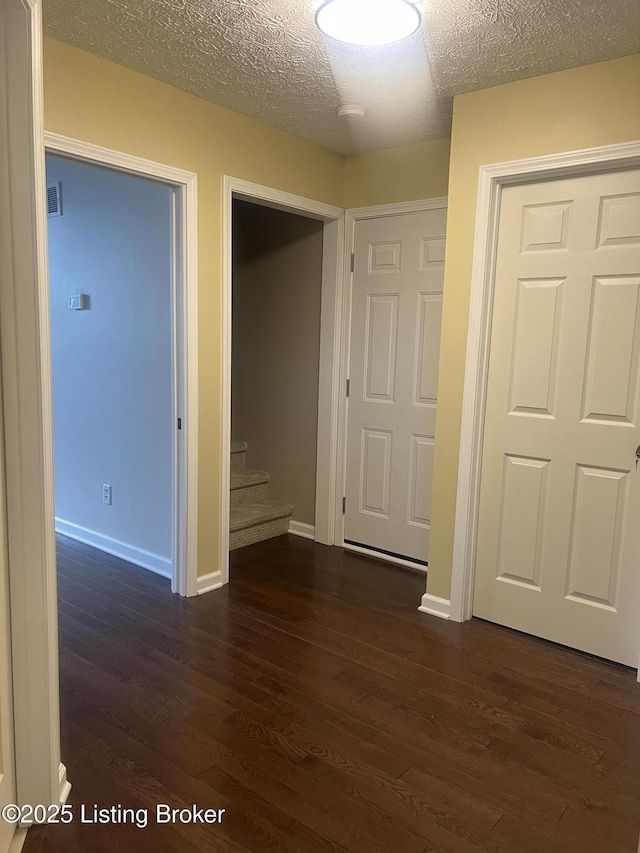 9403 Alex Ct, Louisville, KY 40299 - hallway with dark wood-style floors, a textured ceiling, and stairs
