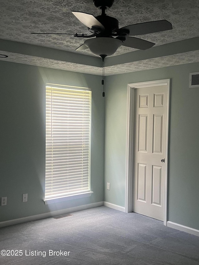 9403 Alex Ct, Louisville, KY 40299 - carpeted empty room featuring a ceiling fan and plenty of natural light