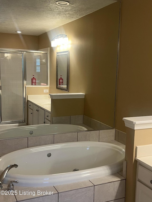 9403 Alex Ct, Louisville, KY 40299 - bathroom featuring a textured ceiling, vanity, and a bath