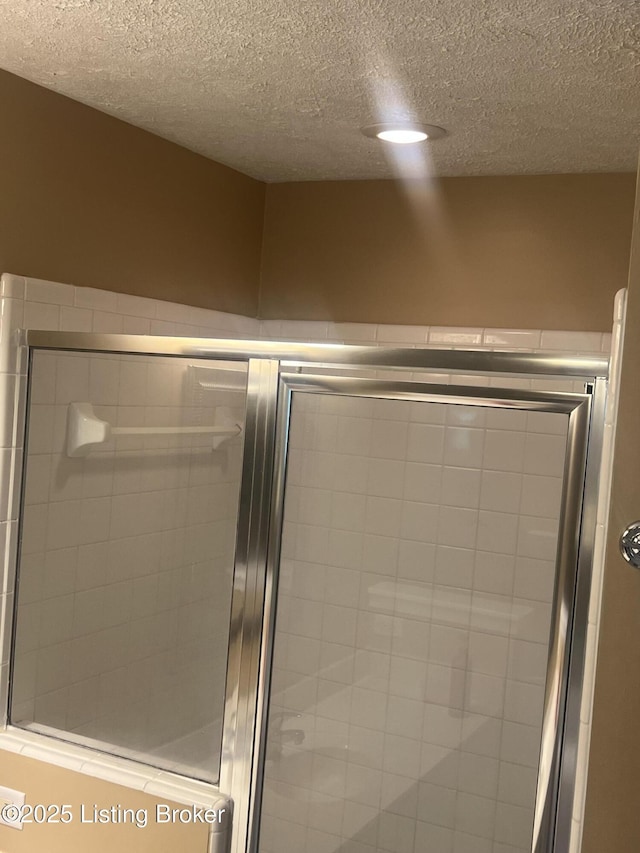 9403 Alex Ct, Louisville, KY 40299 - bathroom with a shower stall and a textured ceiling