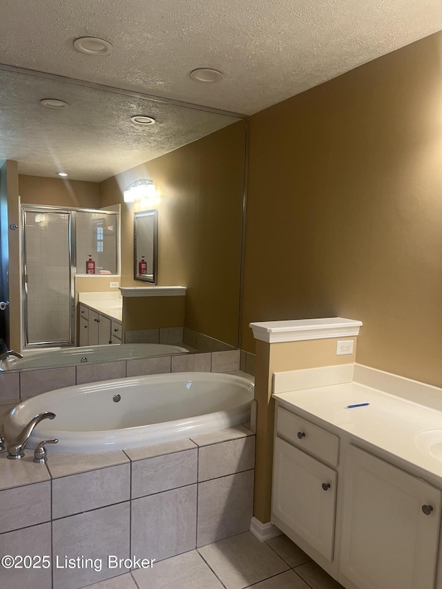 9403 Alex Ct, Louisville, KY 40299 - full bath with vanity, a textured ceiling, a garden tub, a shower stall, and tile patterned flooring