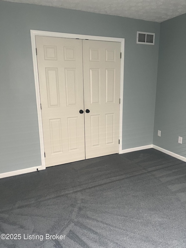9403 Alex Ct, Louisville, KY 40299 - unfurnished bedroom featuring dark carpet and a closet