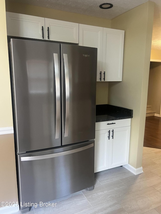 9403 Alex Ct, Louisville, KY 40299 - kitchen with freestanding refrigerator, white cabinets, and light wood finished floors