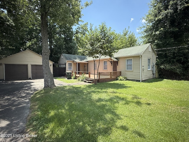 934 Palatka Rd, Louisville, KY 40214 - view of front facade featuring an outbuilding, a detached garage, a wooden deck, and a front yard