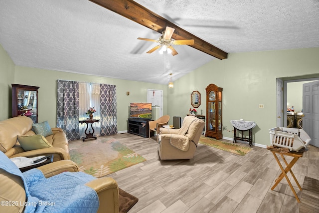 1291 Lipps Ln, Louisville, KY 40219 - living room featuring washing machine and clothes dryer, a textured ceiling, light wood finished floors, and a ceiling fan
