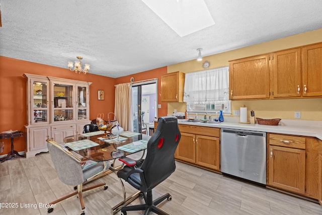 1291 Lipps Ln, Louisville, KY 40219 - kitchen with dishwasher, a skylight, light countertops, a textured ceiling, and a chandelier