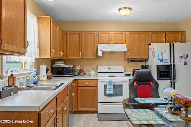 1291 Lipps Ln, Louisville, KY 40219 - kitchen featuring white appliances, ventilation hood, light countertops, light wood finished floors, and a textured ceiling