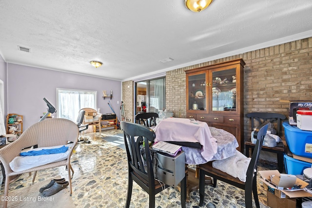 1291 Lipps Ln, Louisville, KY 40219 - dining room featuring a textured ceiling and brick wall