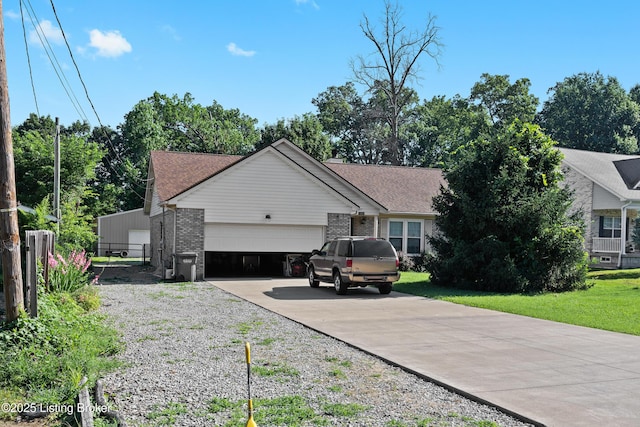 1291 Lipps Ln, Louisville, KY 40219 - view of front of property with an attached garage, driveway, brick siding, and roof with shingles