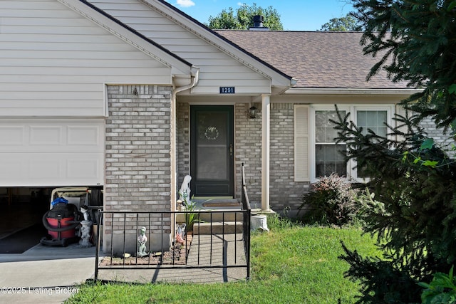 1291 Lipps Ln, Louisville, KY 40219 - view of exterior entry with brick siding, a garage, and a shingled roof