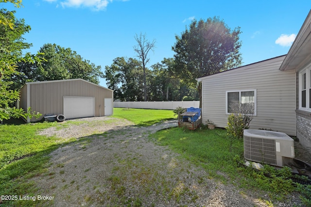 1291 Lipps Ln, Louisville, KY 40219 - view of yard featuring a detached garage, an outdoor structure, and driveway