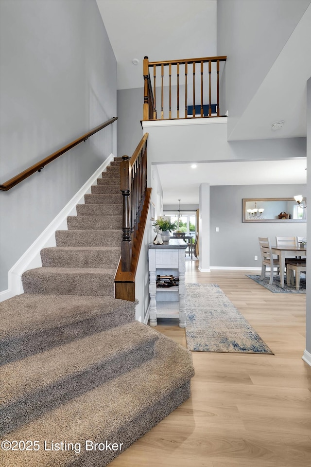 124 Shadow Rock Ct, Shepherdsville, KY 40165 - stairs with wood finished floors and a chandelier
