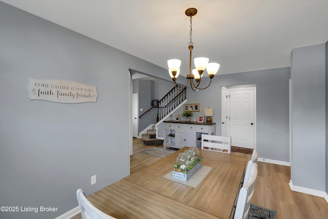 124 Shadow Rock Ct, Shepherdsville, KY 40165 - dining area with a chandelier, stairs, and light wood-style flooring